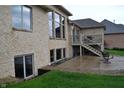 Backyard featuring a brick exterior, a deck with stairs, a patio, and a well-manicured lawn at 5361 Ashby Ct, Greenwood, IN 46143