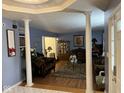 Elegant living room featuring decorative columns, hardwood floors, and classic furnishings at 5640 Dapple Ct, Indianapolis, IN 46228
