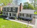 Aerial view of a two-story home with landscaped yard and inviting front entrance at 5829 Lasalle St, Indianapolis, IN 46220