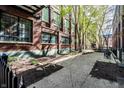 Beautifully landscaped courtyard with mature trees and walking paths, bordered by a black metal fence at 624 E Walnut St # 46, Indianapolis, IN 46204