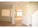 Open-concept entryway boasts neutral paint, and transitions to the living room, creating a light-filled space at 6725 Tramcus Dr, Indianapolis, IN 46260