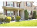 An attractive two-story home features well-maintained landscaping, brick accents and a welcoming front porch at 6725 Tramcus Dr, Indianapolis, IN 46260