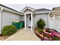 This property features a covered entryway and a small garden with privacy fence at 921 Kimberly Ave, Westfield, IN 46074