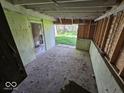 Inside a carport showing cinderblock walls and a view of the yard at 100 N Blue River Dr, Edinburgh, IN 46124