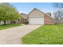 Attractive single-story home featuring brick and siding exterior, attached garage, and neatly maintained landscaping at 1170 Runningbrook Dr, Avon, IN 46123