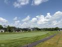 Scenic view of the golf course featuring beautifully landscaped grounds and luxury homes in the background at 1509 Chatham Rdg Ct, Westfield, IN 46074