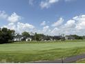 Scenic view of the golf course featuring beautifully landscaped grounds and luxury homes in the background at 1509 Chatham Rdg Ct, Westfield, IN 46074