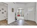 Inviting foyer with hardwood floors leading to a bright living area and features a view of the downstairs half-bathroom at 15120 Downham Dr, Fishers, IN 46037
