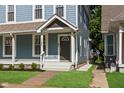 A view of a blue duplex with inviting steps and landscaping with green grass at 1641 N Cornell Ave, Indianapolis, IN 46202