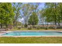 Backyard in-ground pool perfect for relaxation and entertainment, surrounded by manicured landscaping at 1840 W 100 N, Columbus, IN 47201