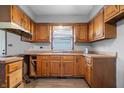 The kitchen is equipped with wooden cabinets, ample countertop space, and a view of the backyard at 1953 N Alton Ave, Indianapolis, IN 46222