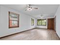 Bright living room with hardwood floors, two ceiling fans, and large windows providing natural light at 1953 N Alton Ave, Indianapolis, IN 46222
