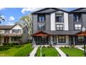 Modern townhome featuring a gray and white exterior, small balconies and well-kept lawn at 2226 Central Ave, Indianapolis, IN 46205