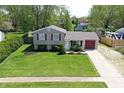 An elevated view of a charming two-story home with a well-maintained lawn and driveway at 251 Yorktown Rd, Greenwood, IN 46142