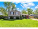 Charming two-story home with stone accents, manicured lawn, and attached garage on a sunny day at 251 Yorktown Rd, Greenwood, IN 46142
