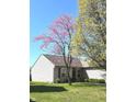 Inviting one-story home with blooming redbud tree and well-maintained front lawn at 2629 Calabash Dr, Indianapolis, IN 46217