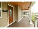 View of a well-maintained front porch with wood flooring and a decorative front door at 344 N Addison St, Indianapolis, IN 46222
