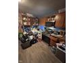 Presents a stainless steel oven, microwave, wooden cabinets, and laminated floors that is in need of decluttering at 3742 S Walcott St, Indianapolis, IN 46227