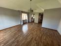 Bright living room features hardwood floors, neutral walls, modern chandelier and an open layout at 379 Vinewood N Dr, Brownsburg, IN 46112