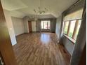 Spacious living room with hardwood floors, gray walls, and lots of natural light from large windows at 379 Vinewood N Dr, Brownsburg, IN 46112