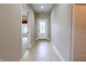 Hallway with tiled flooring leading to the front door and view into the adjacent living area at 4061 Melbourne Dr, Columbus, IN 47203