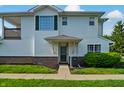 Attractive condo featuring brick accents, green shutters, and a well-kept lawn at 4948 Potomac Square Pl, Indianapolis, IN 46268