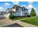 Desirable condo showcasing an attached garage, balcony, and manicured landscaping at 4948 Potomac Square Pl, Indianapolis, IN 46268