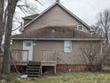 View of the back of the house showing the siding, deck, and backyard area at 501 N Tacoma Ave, Indianapolis, IN 46201