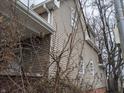 Side view of home, showing the siding, windows and trees at 501 N Tacoma Ave, Indianapolis, IN 46201