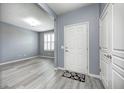 Bright foyer with gray walls, stylish flooring, and a view into the adjacent living space at 5110 Lilium Dr, Plainfield, IN 46168