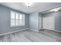 Inviting living room featuring sleek flooring, a large window with shutters, and neutral wall paint at 5110 Lilium Dr, Plainfield, IN 46168