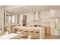 Modern kitchen featuring a large island with seating, white cabinets, and stainless steel appliances at 5488 Stonewood Ct, Bargersville, IN 46106