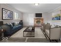 Elegant living room with a cozy fireplace, stylish furnishings, and a modern decor at 5719 Laurel Hall Dr, Indianapolis, IN 46226