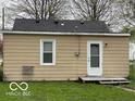 This home includes a functional back door and access to the yard, with simple exterior features at 598 Young St, Franklin, IN 46131