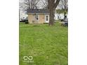 View of the expansive yard with a charming vintage windmill, offering lots of outdoor space at 598 Young St, Franklin, IN 46131