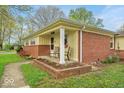 Inviting brick front porch with stylish chairs, perfect for relaxing outdoors at 6340 Monitor Ln, Indianapolis, IN 46220