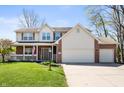 Inviting two-story home with brick and vinyl siding, featuring a well-maintained lawn and an attached garage at 6373 Thornridge Dr, Avon, IN 46123