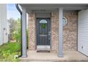 Inviting front door features decorative wreath, sidelight window, and 'Welcome' message at 6459 Titania Dr, Indianapolis, IN 46236