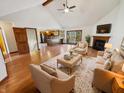 Bright living room featuring hardwood floors, fireplace, and a view to an updated kitchen at 6618 Crystal Springs Dr, Avon, IN 46123