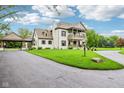 Charming two-story home with a circular driveway and well-maintained landscaping at 6990 Old Hunt Club Rd, Zionsville, IN 46077