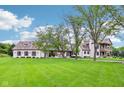 Two-story home featuring a large front yard and a classic architectural design at 6990 Old Hunt Club Rd, Zionsville, IN 46077