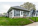 Single-story home with a glass-enclosed porch, a tidy lawn, and a welcoming pathway at 71 S 9Th Ave, Beech Grove, IN 46107