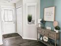 Charming entryway with console table and decorative niche, showcasing the home's stylish interior details at 7141 Lillian Pl, Cumberland, IN 46229