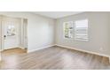 Open living room featuring wood-look flooring, neutral paint, and a view of the outdoors from the window at 7277 Governors Row, Avon, IN 46123