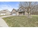 Charming two-story home with brick facade, attached two car garage, and landscaped front yard at 769 Raintree Dr, Avon, IN 46123
