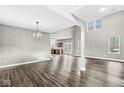 Bright living room with dark floors, high ceilings, many windows and chandelier at 769 Raintree Dr, Avon, IN 46123