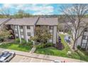 An aerial view showcases the building's surroundings, highlighting the landscaping and nearby parking at 8140 Shorewalk Dr # C, Indianapolis, IN 46236