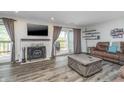 Cozy living room with a fireplace, deck access, and a comfortable seating arrangement at 8140 Shorewalk Dr # C, Indianapolis, IN 46236
