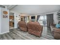 Inviting living room featuring new flooring, a fireplace, and sliding doors leading to the deck at 8140 Shorewalk Dr # C, Indianapolis, IN 46236