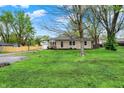 Charming stone home featuring a well-maintained lawn and mature shade trees at 840 N Indiana St, Mooresville, IN 46158